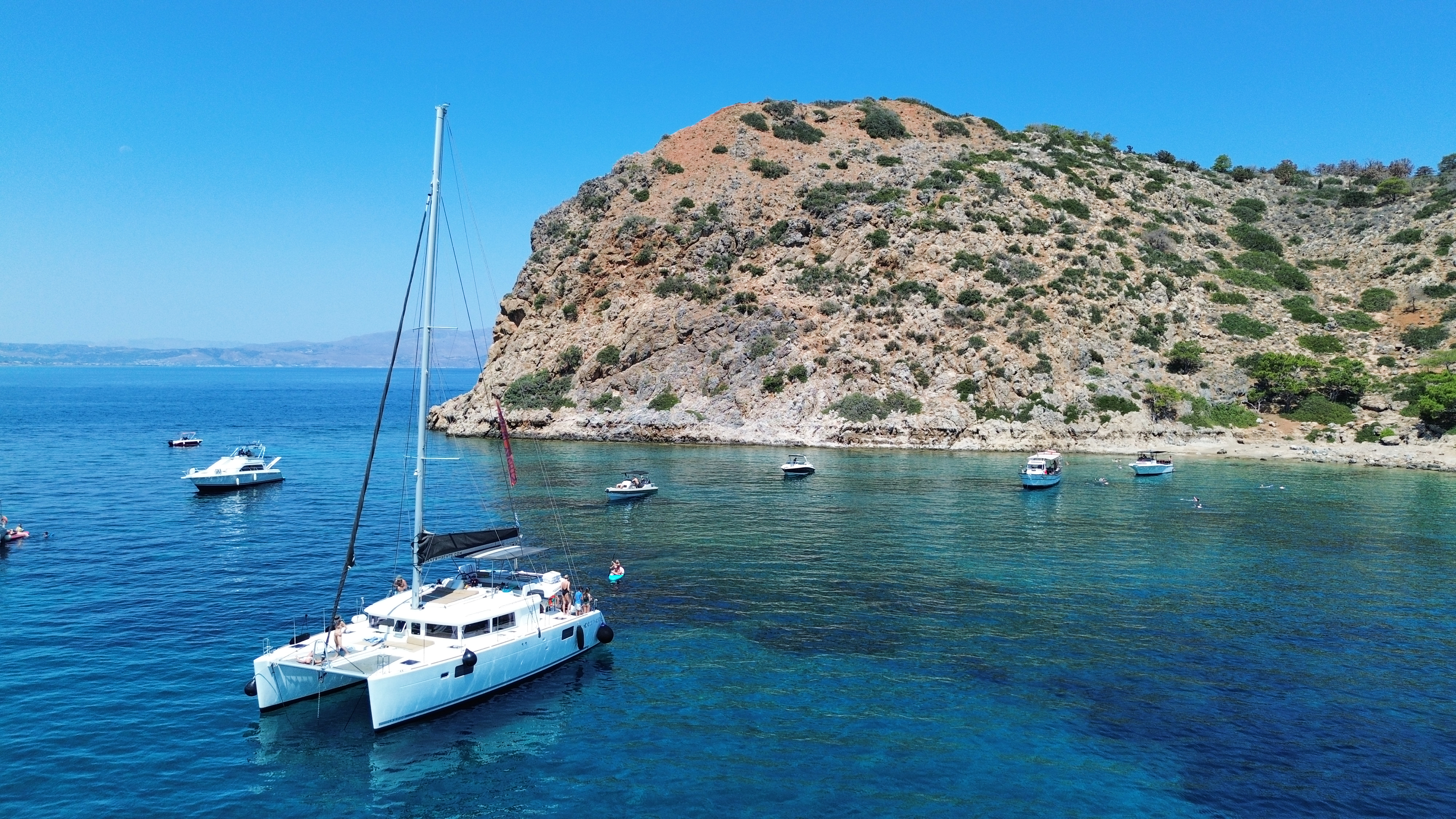 Premium catamaran near limestone cliffs in Crete