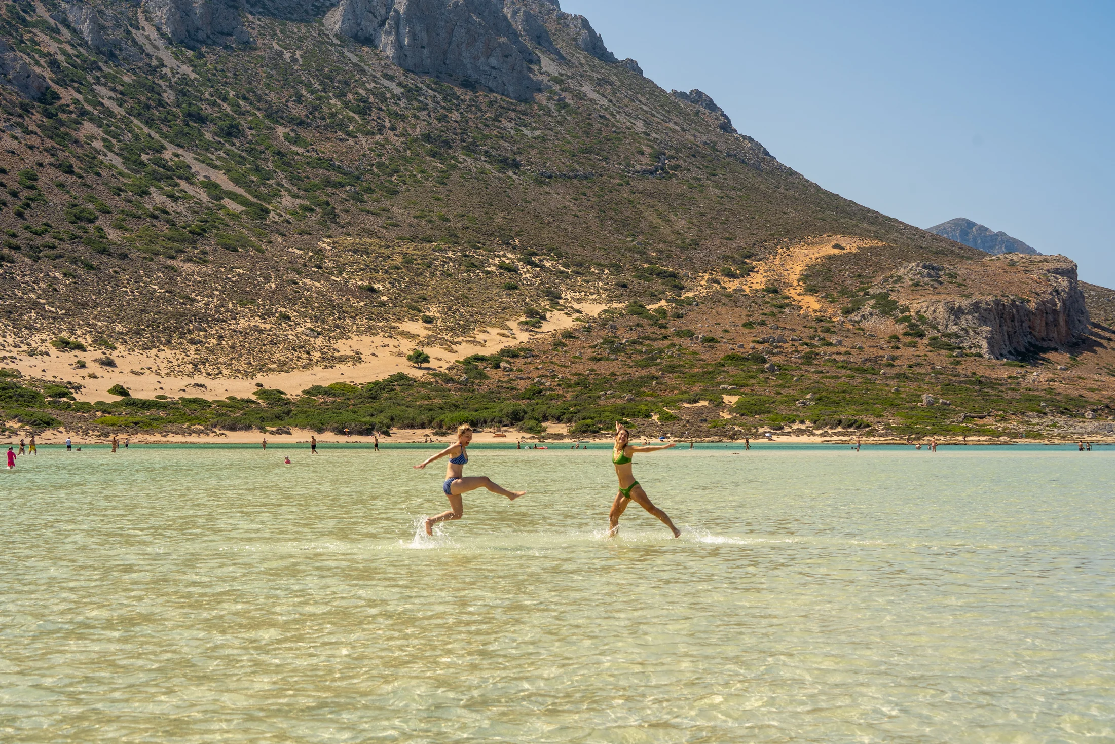 Guests walking through the shallow water at Balos